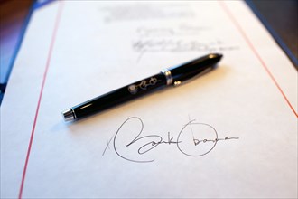 Close-up detail of President Obama's signature on a bill, and a pen used for the signing, aboard Air Force One on a flight from Buckley Air Force Base, Denver Colorado to Phoenix, Arizona 2/17/09.  .