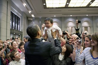 President Barack Obama greets the daughter of a U.S. embassy staff member at the Hotel Okura in Tokyo, Japan, Nov. 14, 2009.  .