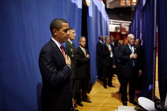 Before giving a policy speech on Iraq, President Barack Obama places his hand on his heart as the national anthem is played backstage  at the Field House, Camp Lejeune, North Carolina 2/27/09. .