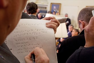 A reporter takes notes while President  Barack Obama and Prime Minister Gordon Brown of the United Kingdom speak to the press in the  Oval Office 3/3/09. .