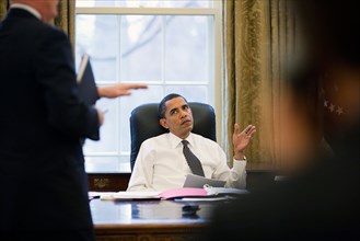 President Barack Obama is briefed prior to making phone calls to foreign leaders in the Oval Office 1/26/09..