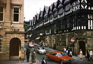 Traffic and pedestrians in front of the Barclays Bank Building in Chester England circa 1973.