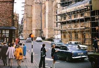 Pedestrians waiting to cross the street in York, England circa 1973.