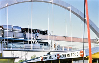 Men working on the monorail at the Texas State above the Mariano's Mexican Food stand Fair circa 1956.