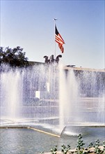 American flag (48 stars) and water fountain at Texas State Fair circa 1954-1956.