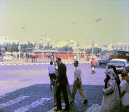 Pedestrians crossing a street in a Casablanca neighborhood circa 1969.