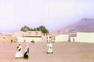 Men walking in a village in Morocco circa 1969.