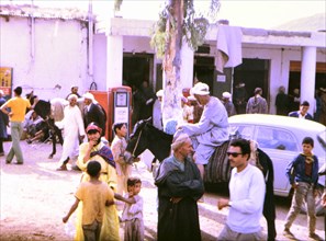 People outside a petrol station in an unidentified city in Morocco circa 1969.