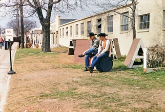 1960 Ft. Worth Stock Show - Two cowboys at the Ft. Worth Stock show sitting on a barrel .