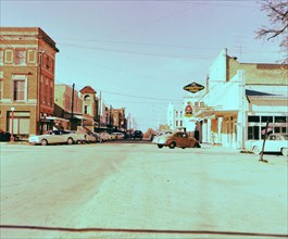 Cars parked on side of street in 1950s Lockhart Texas circa 1957.