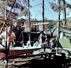 Man at camp site in late 1950s (ca. 1957).