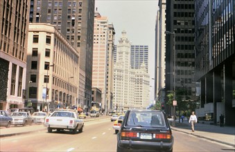 Traffic in downtown Chicago heading towards the Wrigley Building (a Volkswagen Rabbit and a Chicago Police car identified) circa 1985.