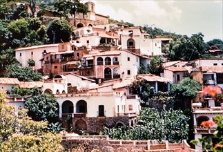 Houses on a hillside in a Mexico city circa 1950-1955 (possibly Taxco Mexico).