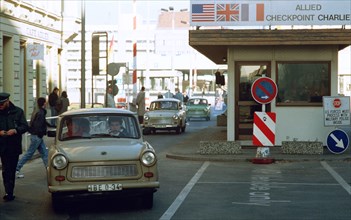 East Germans drive their vehicles through Checkpoint Charlie as they take advantage of relaxed travel restrictions to visit West Germany..