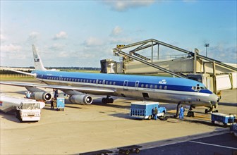 KLM Royal Dutch Airlines jet at a gate at an airport in Europe (possibly Schiphol Amsterdam airport in Netherlands)  - circa 1975.