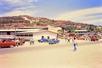 (R) Pedestrians at market in a Honduras village circa 1987.
