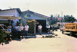 (R) People outside a small restaurant in La Lima Honduras circa 1987.