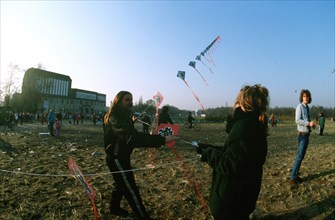 East Germans fly kites as they celebrate the demolition of a section of the Berlin wall at Potsdamer Platz..
