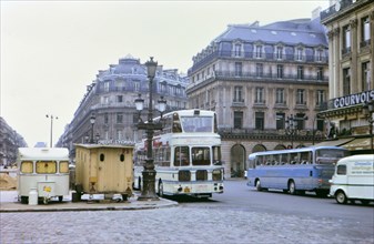 1972 France - (R) - Credit Lyonnais Bank and buses on road in Paris France.