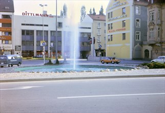 1972 - (R) - Traffic and fountain in city of Winterthur, Switzerland.