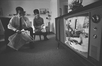 Man and Woman watching Vietnam War TV