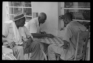 Men Playing Checkers Outside in Segregated Neighborhood