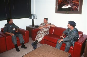 DESERT SHIELD - Colin Powell in fatigues in Saudi Arabia talking with Saudi Arabian pilots.