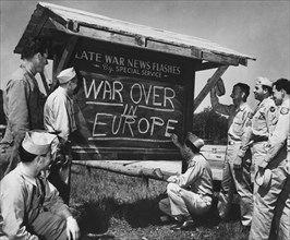 An Army private is shown breaking the news of the end of the war in Europe
