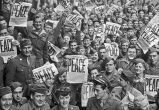 VE Day - Soldiers hold up the Stars and Stripes newspaper