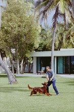 President Nixon plays with his dog King Timahoe.