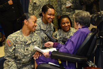 Soldiers greet and gather around World War II Army veteran 106-year-old Alyce Dixon