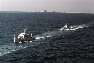 1979 - A port bow view of two Qatarian large patrol craft underway.