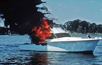 Cabin cruiser on fire as Coast Guard arrives to extinguish the fire