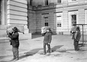 Workers carrying bags of franked mail at the U.S. Capitol