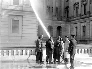 Men cleaning the exterior of the U.S. Capitol