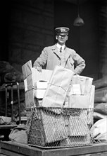 Mail man with a basket full of parcel post packages