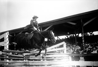 Miss Helen Buchanan horse jumping over rails