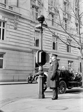 Policeman in Washington D.C. using a Fire Department call box