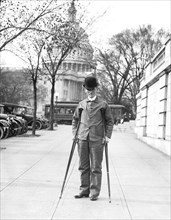 Older man on crutches in front of the United States Capitol
