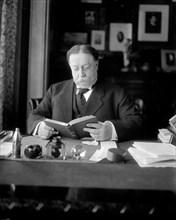 Secretary of War William Howard Taft sitting at his desk