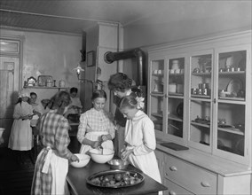 Women and girls working in a kitchen