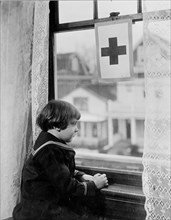 Red Cross - Little girl looking out window