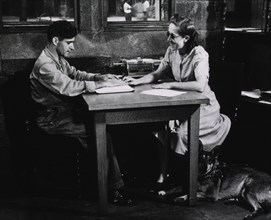 A blind woman teaching a blind man to read Braille