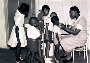 Children standing in line to see the dentist.