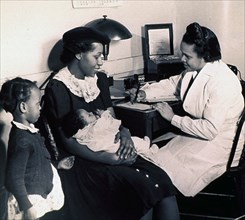 African American nurse is recording a medical history