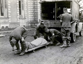 Moving a wounded man from an ambulance