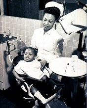 African American little girl is sitting in a dental chair