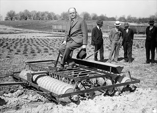 Man in suit on farm machinery