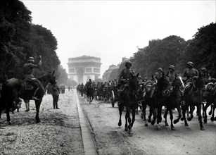 German soldiers marching past the Arc de Triomphe in Paris
