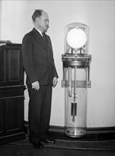 Man with a Riefler pendulum clock